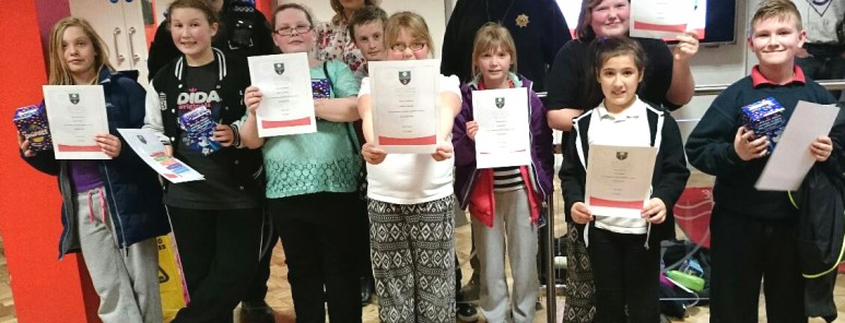 Youth club participants pick up certificates at the fire service training centre
