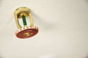 A photo of a sprinkler on a ceiling