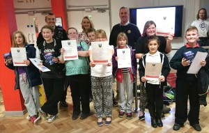 Youth club participants pick up certificates at the fire service training centre